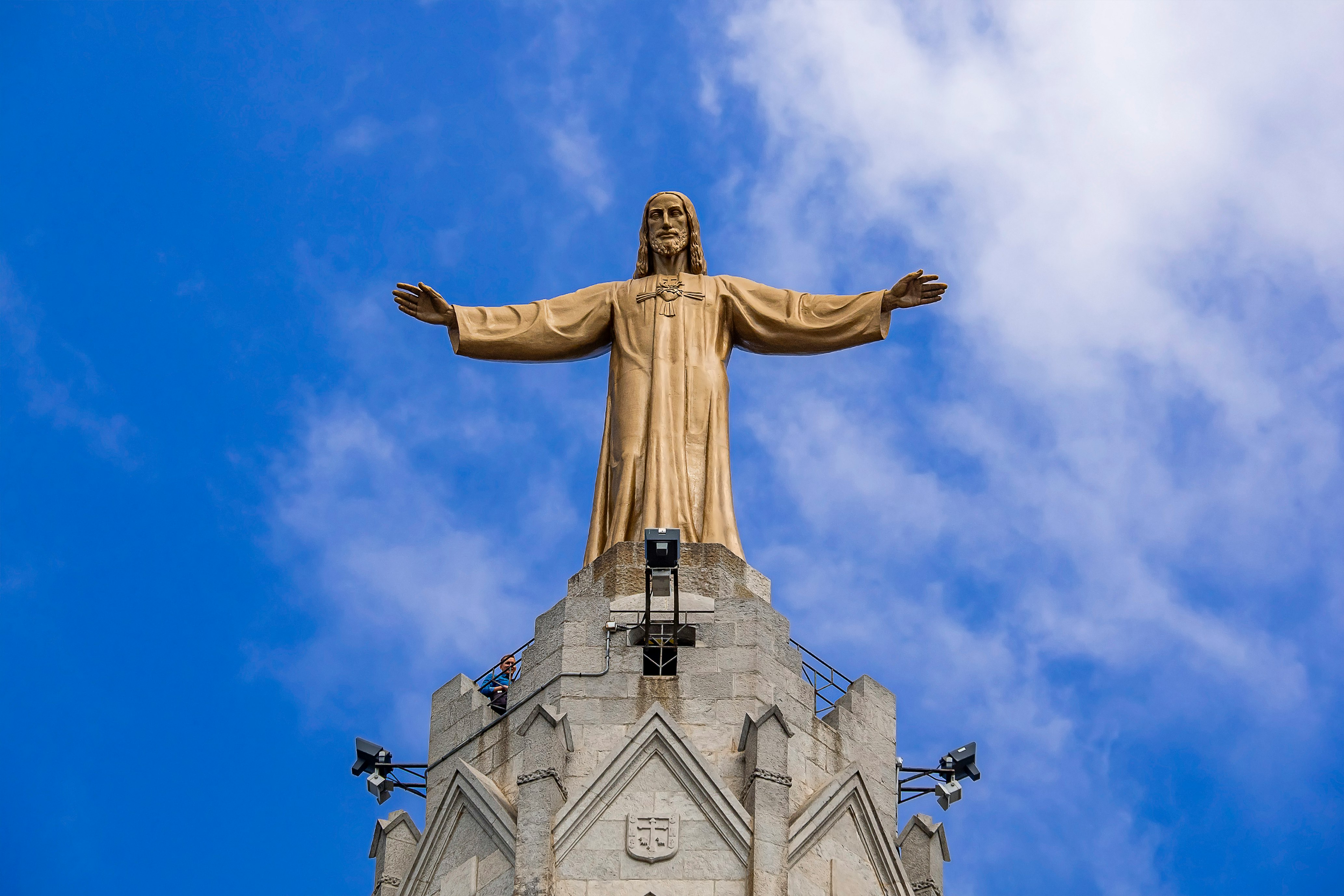 gold statue under blue sky